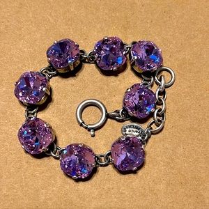 Lilac Swarovski crystals over silver bracelet.